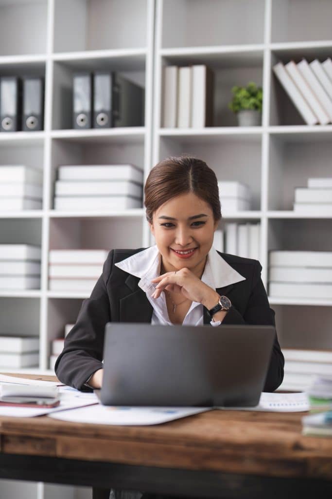 Business woman using calculator for do math finance on wooden desk in office and business working